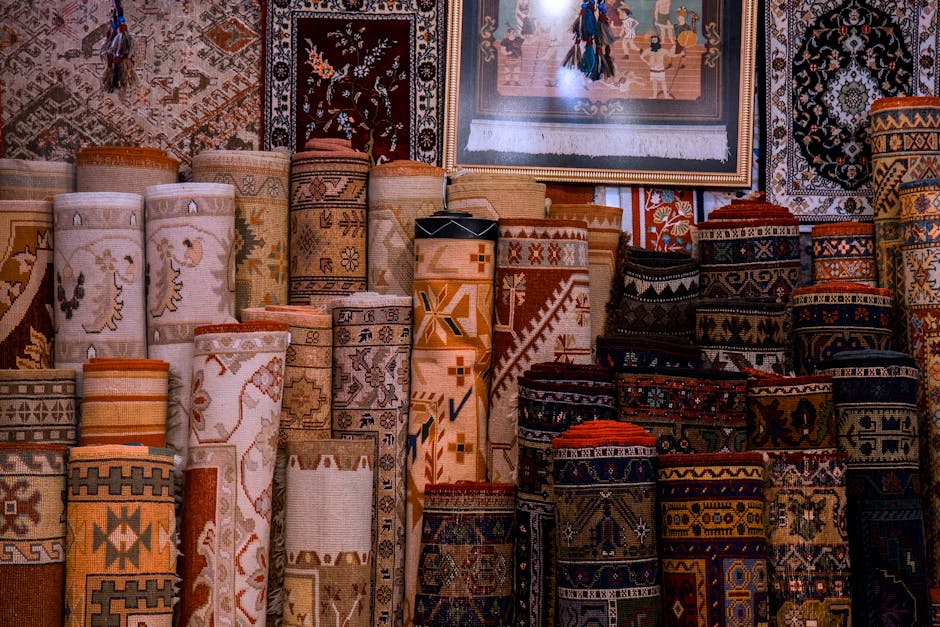 Vibrant collection of traditional rolled carpets on display in a cultural bazaar setting.